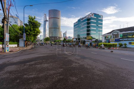 Photo for Ho Chi Minh, Viet Nam - 30 June 2023: Morning at Ho Chi Minh City street, commonly known by its previous name, Saigon is the largest and most populous city in Vietnam. View to Bitexco tower - Royalty Free Image