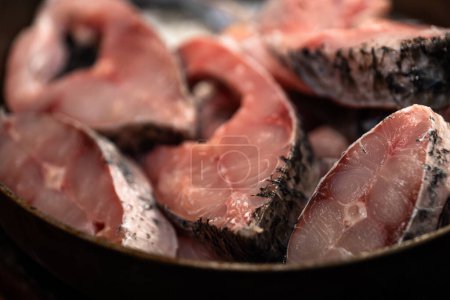 Photo for A close-up of a bowl of uncooked raw chopped fish meat. The meat is chopped into small pieces and is a slightly translucent color. - Royalty Free Image