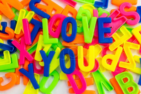 Photo for This stock image shows the words "I love you" made from colorful letter magnets on a plain background. - Royalty Free Image
