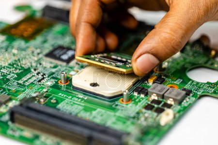 Photo for Technician meticulously repairs a laptop motherboard using a variety of specialized tools - Royalty Free Image