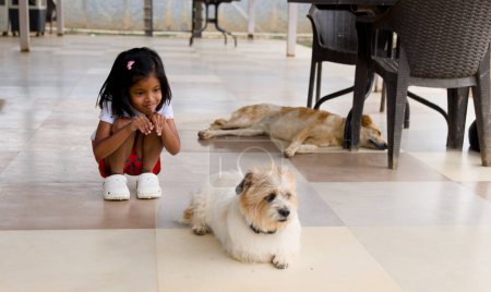 Selective focus brings the girl and dog into sharp relief