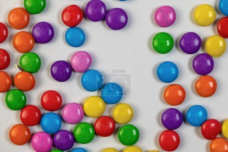 A delightful assortment of circular candies in a rainbow of colors, playfully arranged