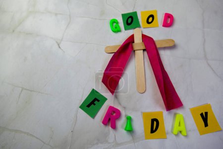 Photo for Simple wooden cross standing upright against a clean, white background. The words "Good Friday" - Royalty Free Image