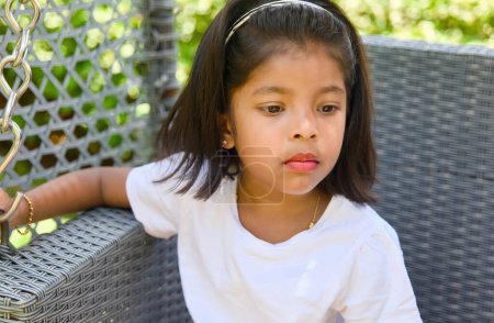 This images is about Portrait of little asian girl looking at camera and thinking