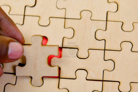 Verbinden Sie die letzten Teile eines Puzzles, das Teamwork, Zusammenarbeit und erfolgreiche Problemlösung in einem Geschäftskonzept symbolisiert.