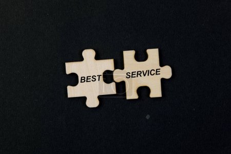 Photo for Jigsaw puzzle pieces forming the words "BEST SERVICE" on a black background. - Royalty Free Image