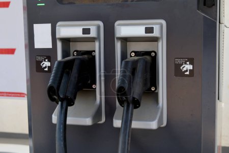 A close-up view of an electric vehicle (EV) charging station plug, highlighting the connection point for clean and eco-friendly transportation