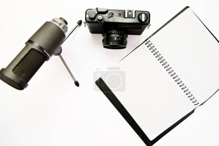 photo camera, microphone, and notepad on a clean white background. Perfect for representing content creation, vlogging, journalism, or writing.