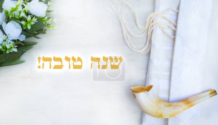 Photo for Translation title: Happy New Year.in HebrewA shofar is placed on a tallit with flowers on a white wooden surface. A symbol of the Rosh Hashanah holiday. Suitable for shana tova greeting card and Yom Kippur. - Royalty Free Image