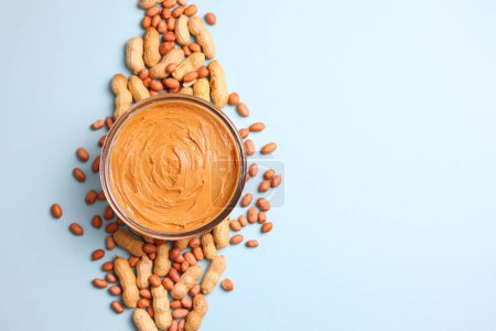peanut butter and raw peanuts on a colored background. High quality photo