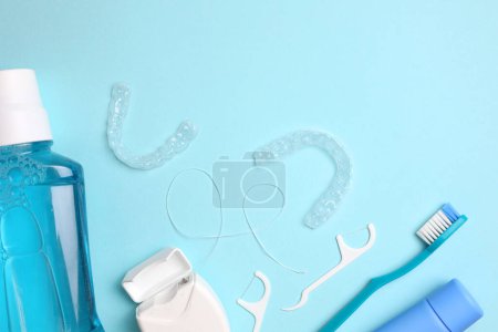 Téléchargez les photos : Aligneurs dentaires en plastique transparent et produits de soins sur un fond coloré. Photo de haute qualité - en image libre de droit
