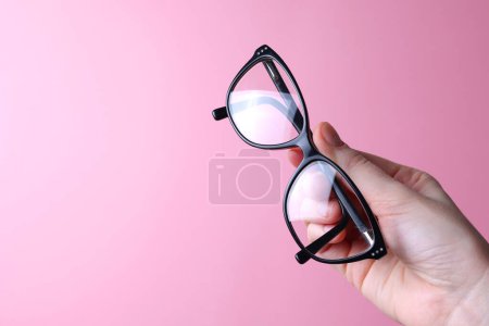 Photo for Glasses for vision correction in the hand on a colored background with space for text. High quality photo - Royalty Free Image