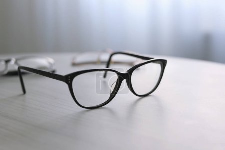Photo for Glasses for vision correction on a table in the interior of the room . High quality photo - Royalty Free Image