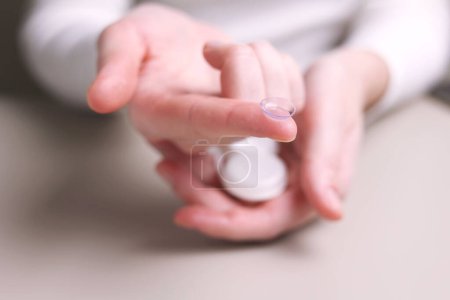 Photo for Contact lenses for vision correction in hands . High quality photo - Royalty Free Image