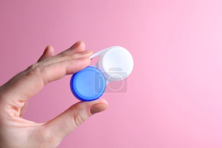 Photo for Contact lens container in hand on a colored background. Vision correction. . High quality photo - Royalty Free Image
