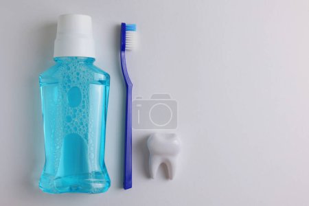 Téléchargez les photos : Un bain de bouche sur un fond coloré. Soins dentaires, santé dentaire. Photo de haute qualité - en image libre de droit