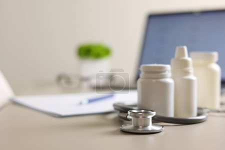 Photo for Doctors desk top view. Set of different doctor accessories on a colored background. Pills, glasses, stethoscope and notebook. . High quality photo - Royalty Free Image