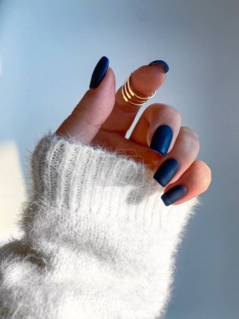 Photo for Beautiful nails manicure photo. Dark blue color matte top nail polish. Female hand, rings, closeup photo, aesthetics. Manicure design, square nail shape.Luxury style, Creative beauty photo. Woman hand - Royalty Free Image
