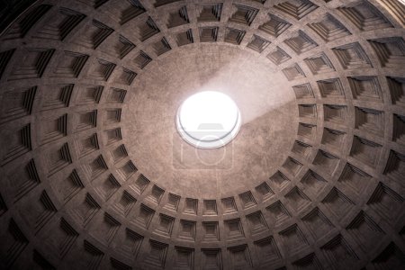Photo for Rome, Italy - November 18, 2018: The famous cassette ceiling dome of Pantheon temple of all the gods with wide open rotunda on the top. Sunlight rays penetrating through oculus aperture on the roof - Royalty Free Image