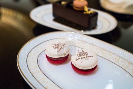 Photo for ABU DHABI, UAE - MARCH 22, 2017: French Macaroons with logo served at the Emirates Palace on 22 March 2017 in Abu Dhabi, UAE. Emirates Palace serves famous coffee with 24 carats gold flakes on top - Royalty Free Image