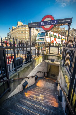 Photo for LONDON, ENGLAND UK - MARCH 3, 2016:Underground entrance and characteristic London bus in Trafalgar Square in London - Royalty Free Image