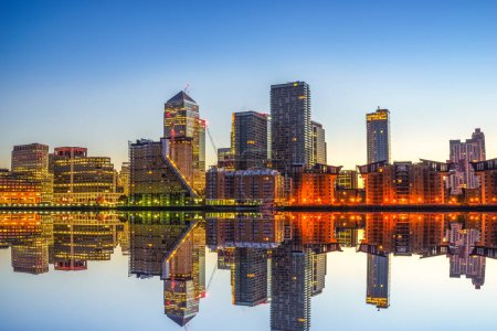 Canary Wharf business district with water reflection at sunrise