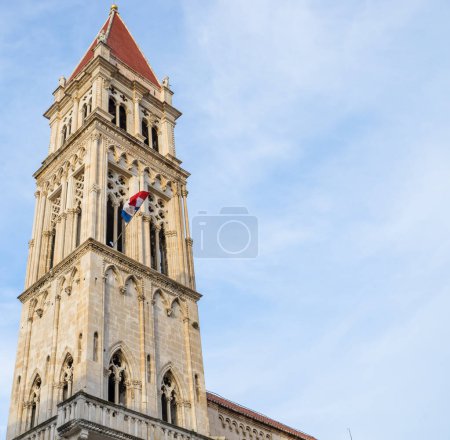Tower of Trogir cathedral vertical view with blue sky