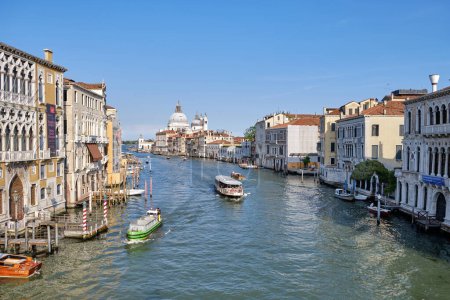 Venice, Italy: Panorama of Venice Grand Canal with boats and Santa Maria della Salute church on sunset from Ponte dell'Accademia bridge.