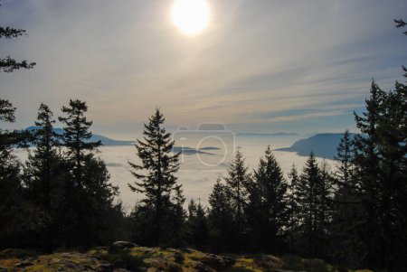 Photo for Beautiful view from a lookout over a cloud and fog filled valley in British Columbia - Royalty Free Image
