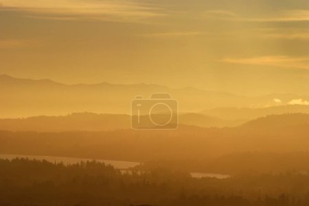 Photo for Hazy or smoky sunset over the south of Vancouver Island with the Olympic Peninsula in the distance. - Royalty Free Image