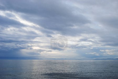 Photo for Reflections of storm clouds on a wavy but calm Juan De Fuca Strait near Victoria, BC - Royalty Free Image