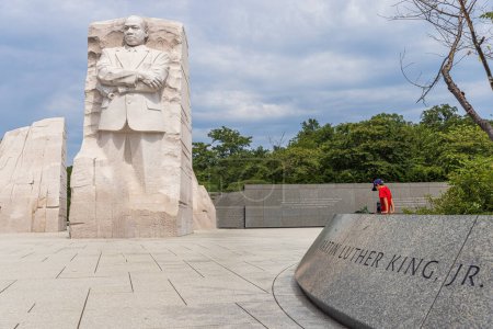 Photo for Boy sitting at the Martin Luther King memorial on cloudy day - Royalty Free Image
