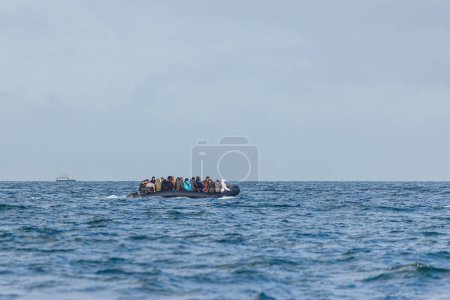 Photo for Migrants on a boat crossing the channel between France and UK heading towards the port of Dover. - Royalty Free Image