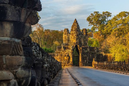 Photo for Stone Gate of Angkor Thom in Cambodia illuminated by the setting sun - Royalty Free Image