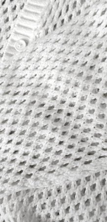 Photo for A sample of knitted white fabric, a jacket in a hole. High quality photo - Royalty Free Image