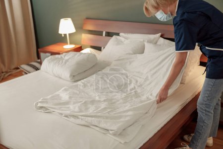 Photo for Cleaning lady making bed in hotel room. Cleaning service concept. High quality photo - Royalty Free Image