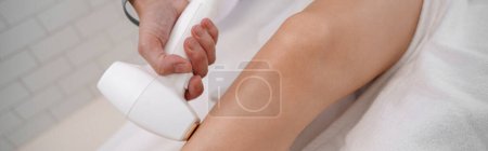 Photo for Hair removing procedure of legs. Laser epilation and cosmetology in beauty salon. High quality photo - Royalty Free Image