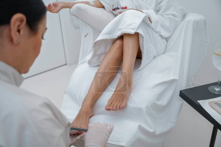 Photo for Close up of nail master making pedicure for female client in spa salone. High quality photo - Royalty Free Image