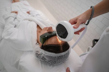 Téléchargez les photos : Cosmetologue fait cavitation rajeunissement traitement de la peau. Levage d'ondes radio - en image libre de droit