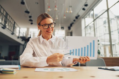 Photo for Woman accountant have online briefing with colleagues while sitting in office. High quality photo - Royalty Free Image