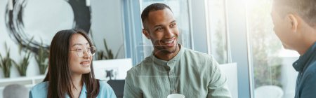 Photo for Smiling group of multiethnic colleagues drinking coffee and talking during break. High quality photo - Royalty Free Image