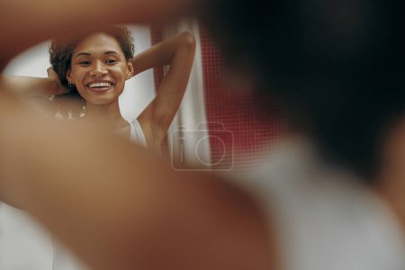 Photo for Young smiling woman holding her arms up and showing underarms and smooth clean skin - Royalty Free Image
