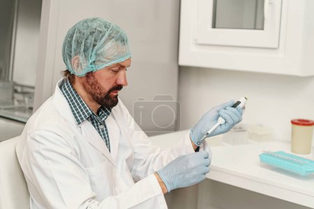 Photo for Scientist dropping substance in test tube in research laboratory. Science and biochemistry concept - Royalty Free Image