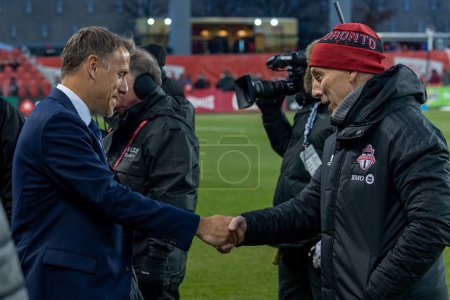 Photo for Toronto, ON, Canada - Match 18, 2023:     Head coach of the Inter Maimi FC Phil Neville  (L) greats Head Coach and Sporting Director of the Toronto FC Bob Bradley (R) before  the match between Toronto FC (Canada) and Inter Miami FC (USA) at BMO Field - Royalty Free Image