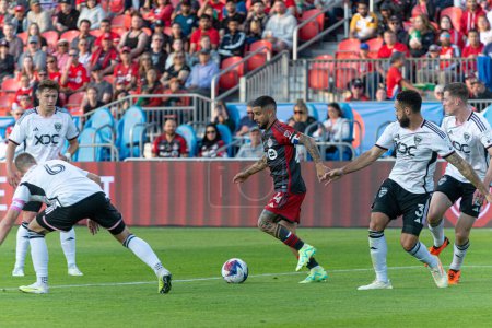 Photo for Toronto, ON, Canada -May 27, 2023:  Lorenzo Insigne #24 forward of the Toronto FC ries to move through opponents during the MLS Regular Season match between Toronto FC (Canada) and  D.C.United (USA) at BMO Field in Toronto, Canada. - Royalty Free Image