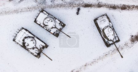 Aerial view of snow-clad tanks in Poznan Citadel during winter, shot by drone.