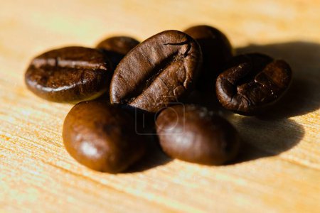 Coffee beans arranged on a raw, freshly split piece of wood.