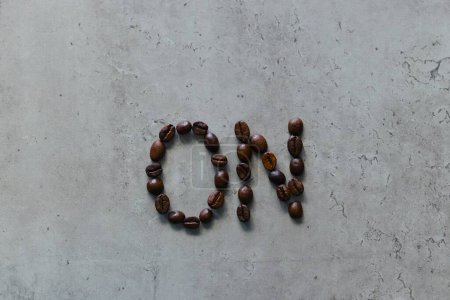 In the photo, the word "on" is created using coffee beans. It symbolizes igniting the mind, body, and individual to spur action and productivity.