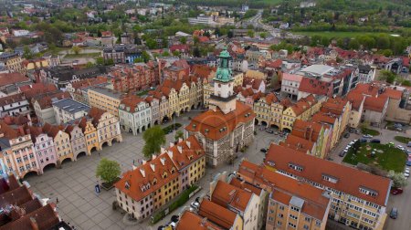 Bird's-eye perspective showcases the vibrant atmosphere of Jelenia Gora's market square, adorned by historic buildings including the 18th-century town hall.