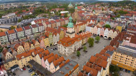 Bird's-eye perspective showcases the vibrant atmosphere of Jelenia Gora's market square, adorned by historic buildings including the 18th-century town hall.